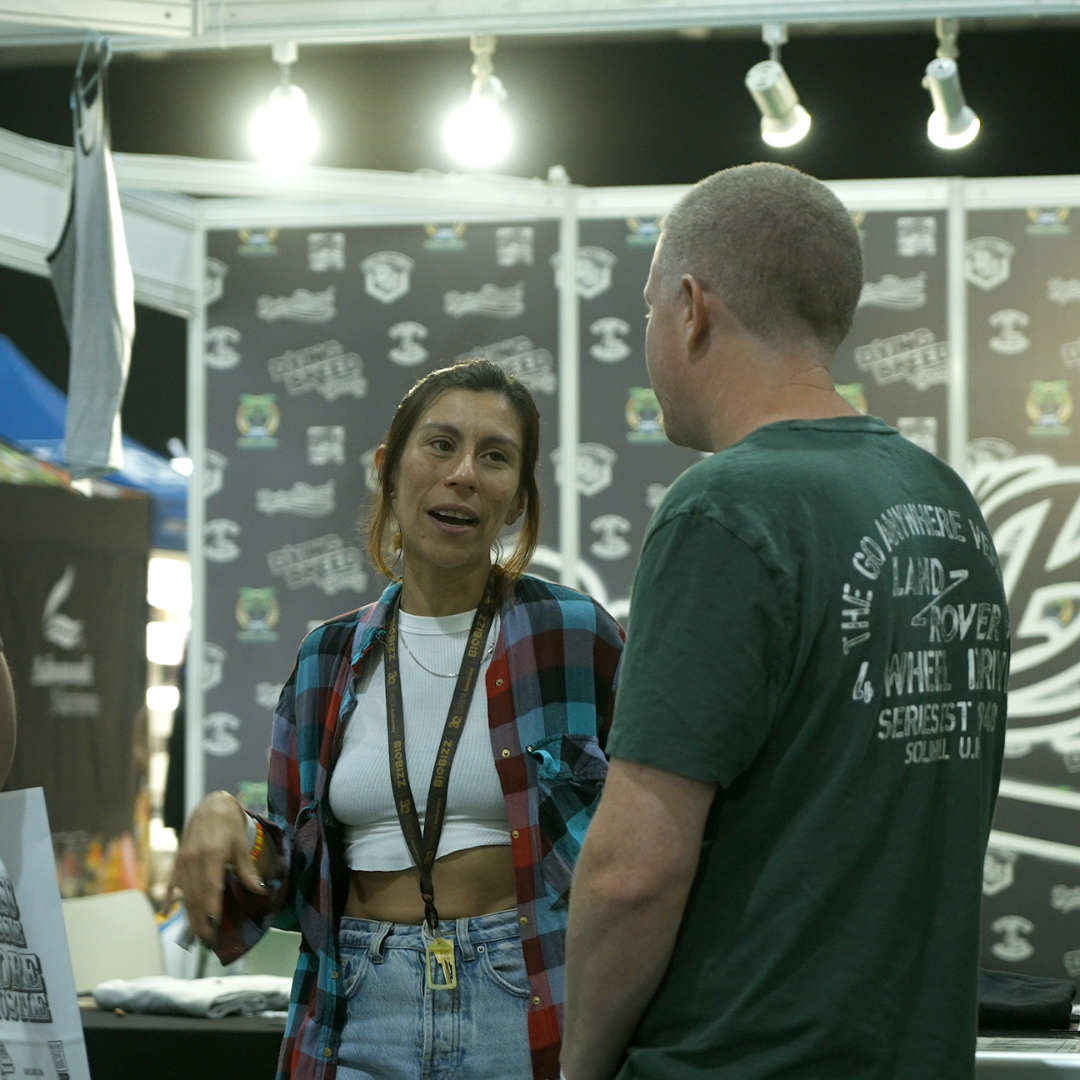 two people speaking at an expo stand
